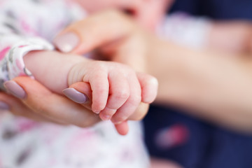little hand of a newborn baby close