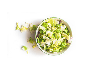 Bowl filled with salad isolated on white background. Healthy food concept - view from top.