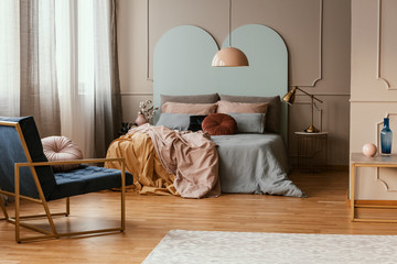 King size bed with pastel colored bedding in classy bedroom