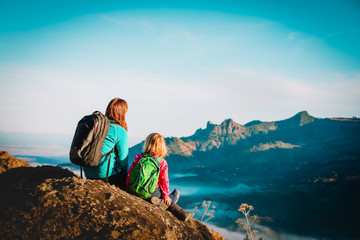 happy mother and daughter travel in mountains