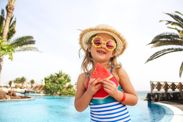 Smilling little girl eating watermelon. Summer, hollidays, travel concept.