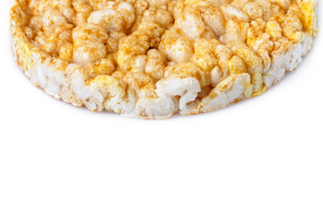 Caramelized corn cakes. Puffed whole grain crispbread isolated on white background. Close-up.