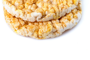 Caramelized corn cakes. Puffed whole grain crispbread isolated on white background. Close-up.