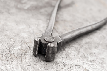 old pincers on a metal workbench