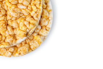 Caramelized corn cakes. Puffed whole grain crispbread isolated on white background. Close-up.