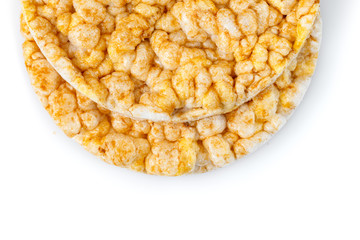 Caramelized corn cakes. Puffed whole grain crispbread isolated on white background. Close-up.