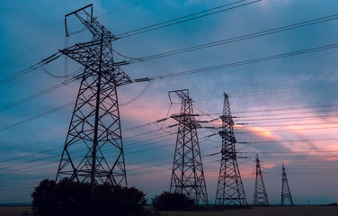  high-voltage  power lines at sunset.