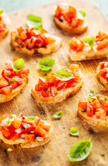 Classic italian bruschetta served on wooden board
