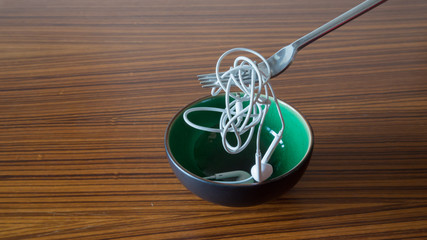 Trying to eat a cup of headphones cables instead of spaghetti