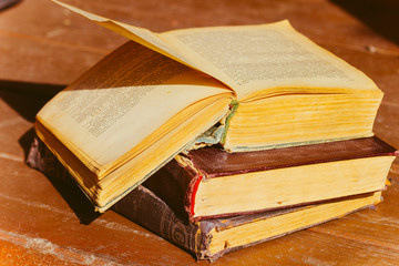 Old ancient historical retro books on the table in the gazebo