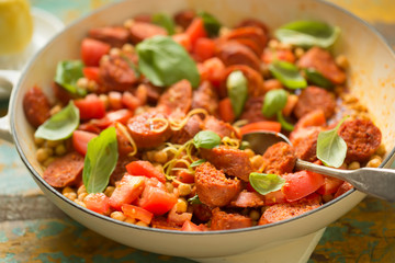 Fried chorizo sausage with chickpeas, tomatoes, lemon & basil 