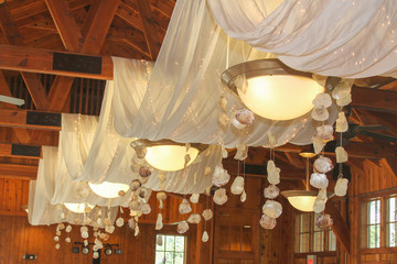 Hanging sea shells and white wedding decorations