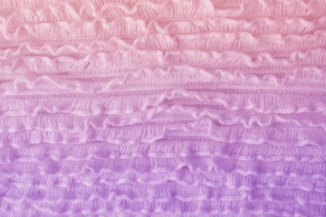 texture of knitted wool with small flounces of canvas, pink, coral