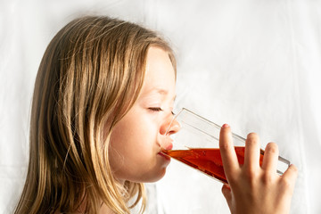 Girl drinking a drink from a glass