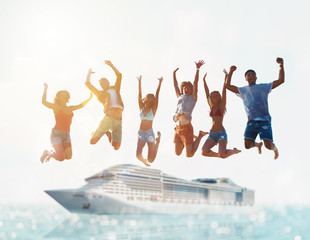 Happy smiling couples playing at the beach with cruiseship in the sea