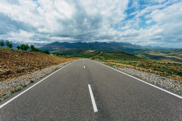 Asphalt road on mountain landscape. Travel concept