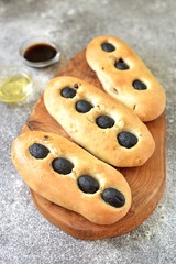 Homemade Italian bread focaccia with dried sausages and basil.