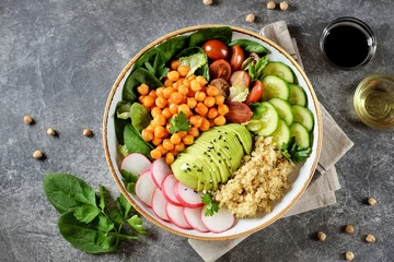 Fotobehang Healthy vegetarian salad with chickpeas, quinoa, cherry tomatoes, cucumber, radish, spinach, avocado and parsley. Ketogenic diet. Top view.  © chudo2307