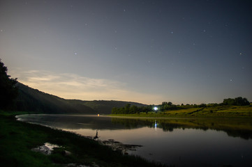 Stars on a moonlit night above the Dniester River