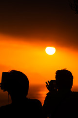 silhouette of man and woman at sunset