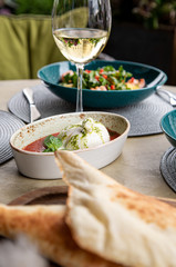 Healthy fruit platter, strawberries raspberries oranges plums apples kiwis grapes blueberries on the dark grey wooden table, top view, close up, selective focus