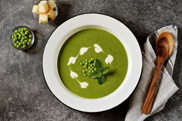 Cream of green pea soup with mint. Healthy food. Top view.