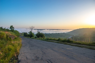 Road on a foggy summer morning