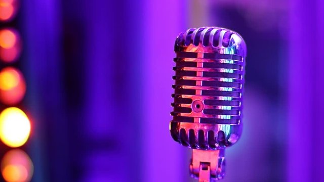 Vintage microphone in a retro club. Spotlight glare. close-up