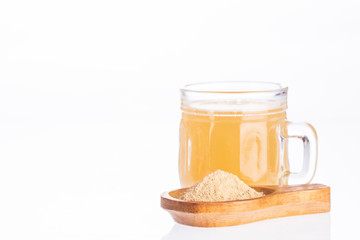 Maca root health drink in a glass with powdered - Lepidium meyenii. White background