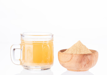 Maca root health drink in a glass with powdered - Lepidium meyenii. White background