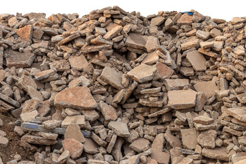 Concrete debris pile, destroyed road.