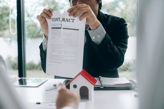 Real estate agents tearing documents for sale contract form customers, real estate concept