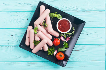 Raw beef sausages with pepper , herbs and ketchup