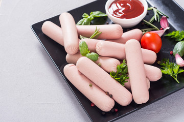 Raw beef sausages with pepper , herbs and ketchup