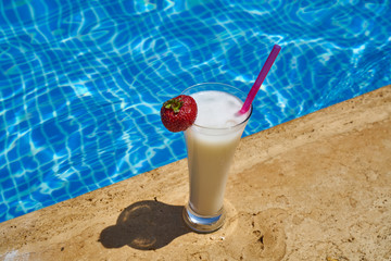 Tasty alcoholic beverage and pool view