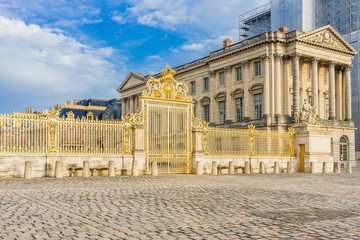 Fototapeta na wymiar Main golden door in exterior facade of Versailles Palace, Paris, France