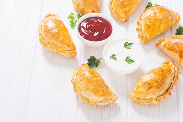 Latin American baked beef empanadas with sauce