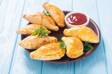 Latin American baked beef empanadas with sauce