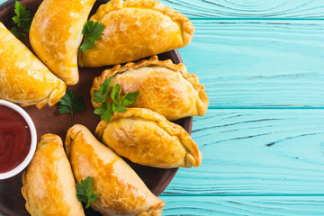Latin American baked beef empanadas with sauce