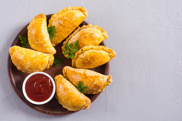Latin American baked beef empanadas with sauce