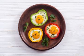 Yellow , red and green pepper with fried eggs