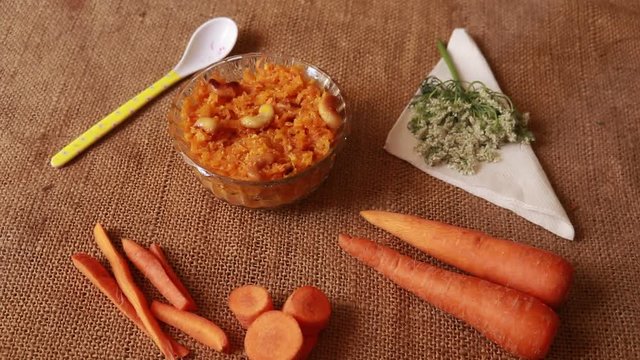 Carrot Halwa- Popular Indian sweet made with carrots isolated on wood
background , selective focus