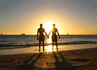 Fototapeta na wymiar Gay couple Silhouette on the beach sunset