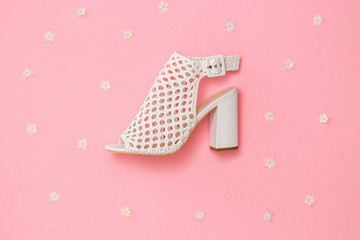 Fashionable leather Shoe on pink background with flowers. Flat lay.