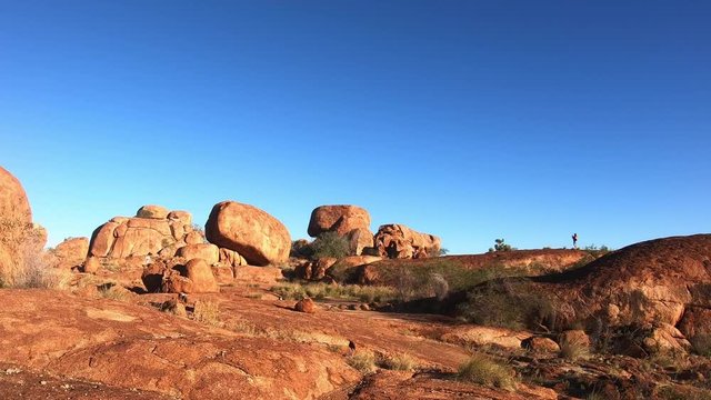 valley,no people,devils marbles,blue sky,australia landmark,australia landscape,australian landmarks,australia outback,outback,boulder,northern,tourist,reserve,vacation,conservation,granite,territory,