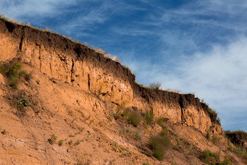 high cliff on the background of blue sky