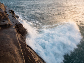 Tide hitting a cliff