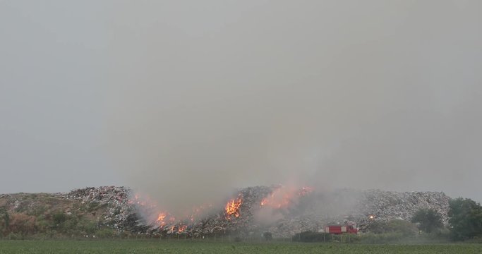 Firefighters at Garbage Dump Landfill Fire Smoke Pollution