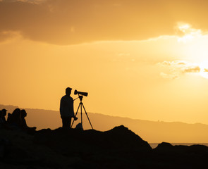 silhouette of a photographer at sunset
