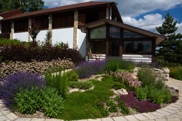 Fototapeta na wymiar house with well-kept garden. Landscape design